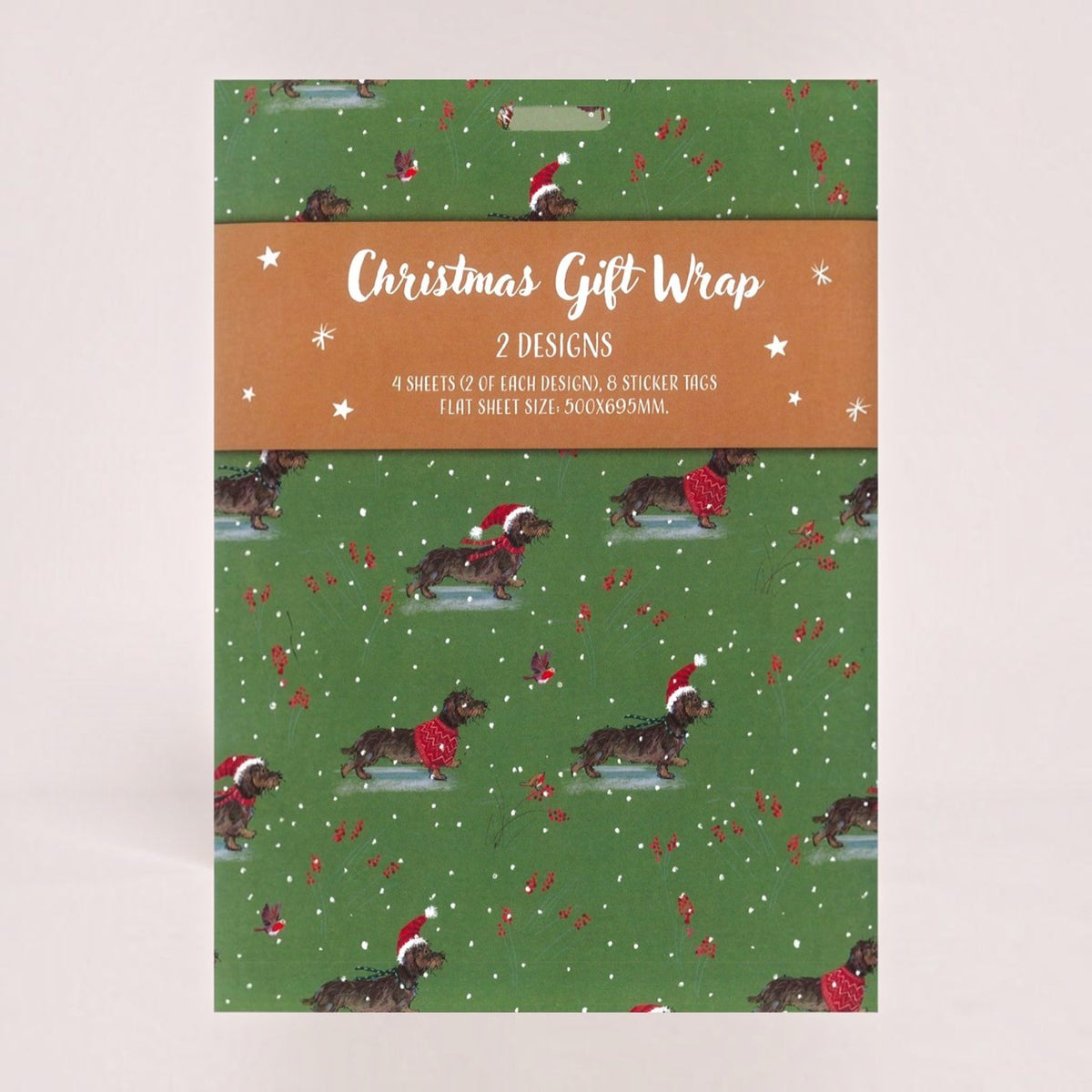 A Christmas-themed gift wrap set featuring a green patterned design with dachshunds wearing Santa hats, red bows, and white snowflakes, along with a brown paper band label that reads 'Christmas Gift Wrap 2 DESIGNS'.