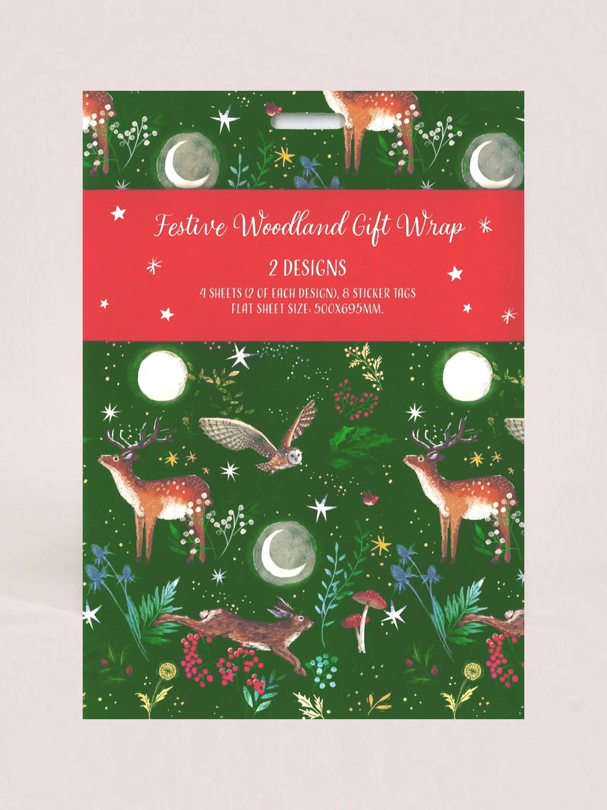 Festive woodland gift wrap packaging featuring a green patterned design with deer, moon phases, stars, and plants, plus a red banner reading 'Festive Woodland Gift Wrap 2 DESIGNS'.