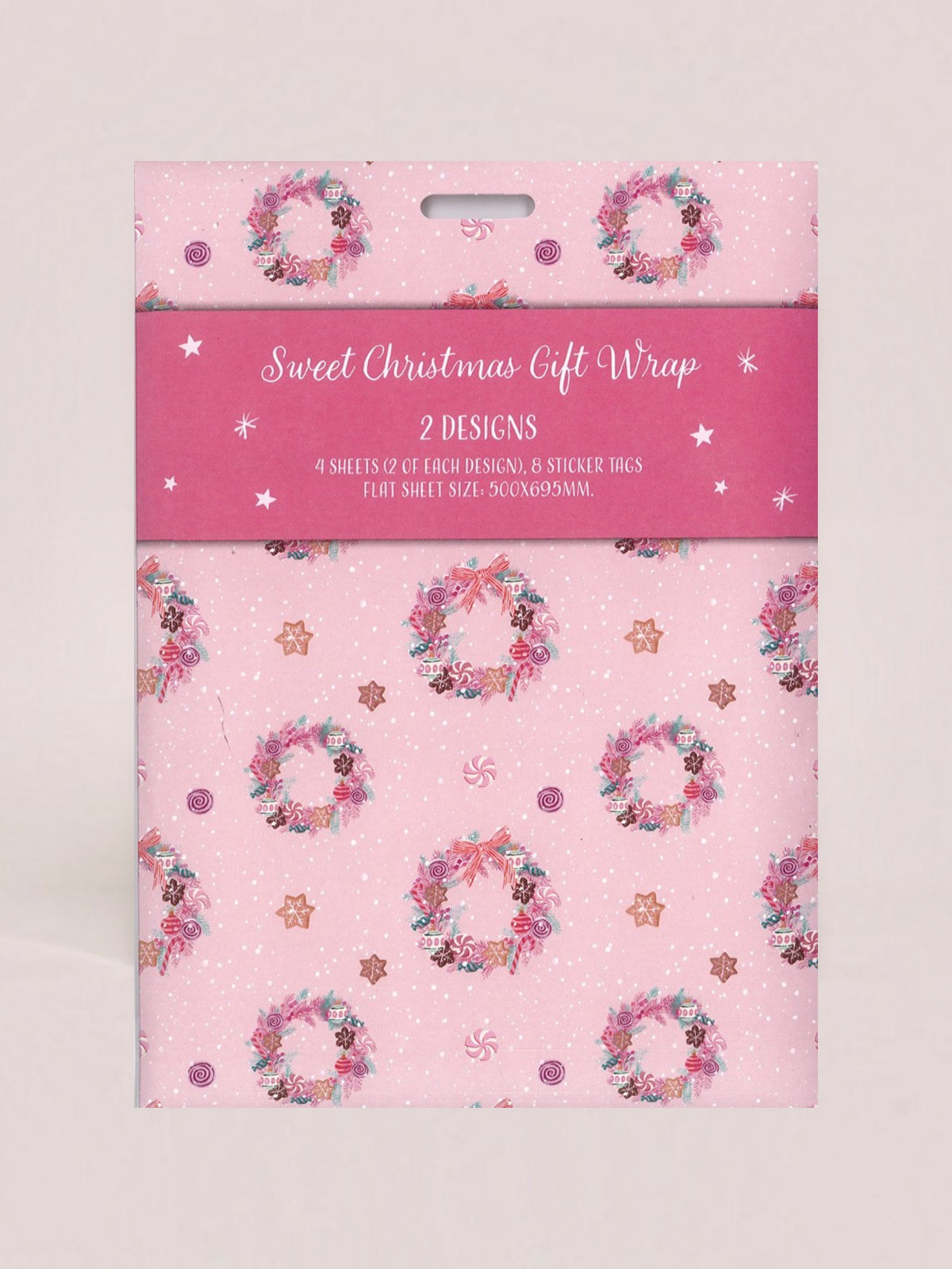Pink Christmas gift wrap packaging with a floral wreath pattern and a pink header card reading 'Sweet Christmas Gift Wrap 2 DESIGNS'.